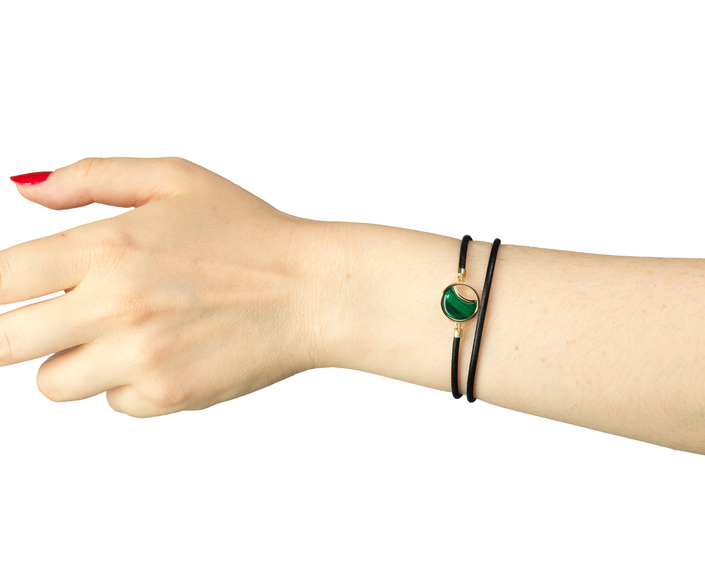 Hand wearing a bracelet with a green stone on a white background